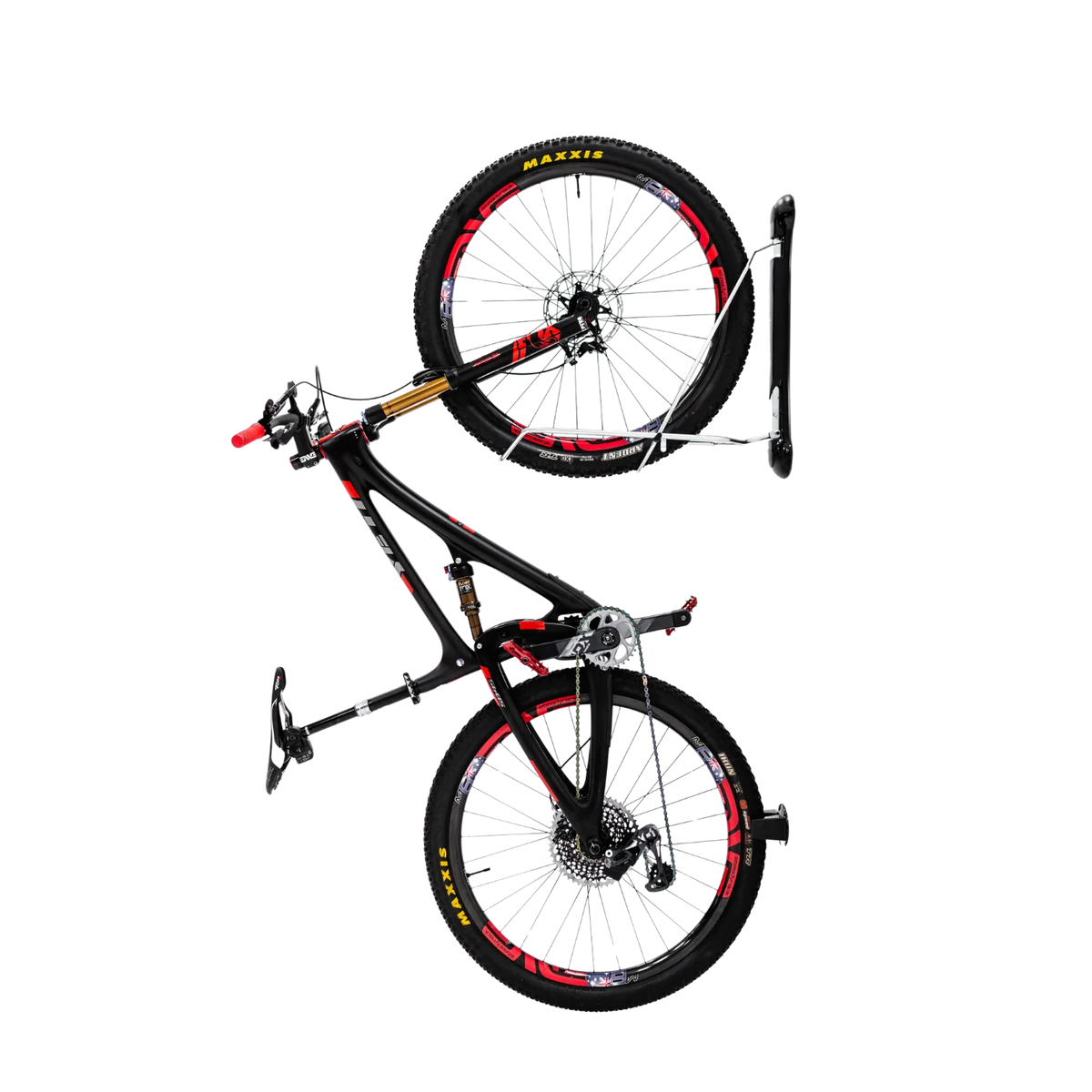 A black full-suspension mountain bike with red and yellow accents, shown suspended vertically on a white wall-mounted bike rack against a solid white background.